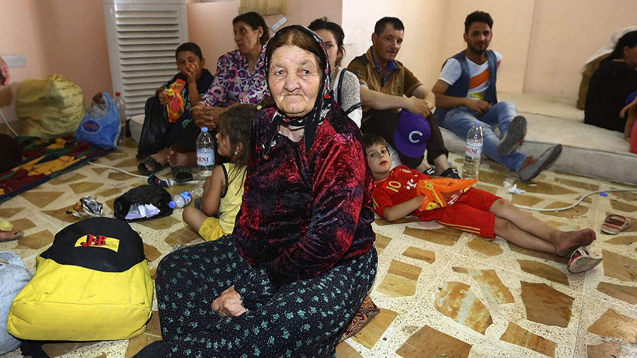 Christian families, who fled from violence in Mosul, gather at a building in Arbil Christian families, who fled from the violence in Mosul, gather at a building which was used as a social club in Arbil, in Iraq's Kurdistan region June 26, 2014. Iraqi forces launched an airborne assault on rebel-held Tikrit on Thursday with commandos flown into a stadium in helicopters, at least one of which crashed after taking fire from insurgents who have seized northern cities. REUTERS/Stringer (IRAQ - Tags: CIVIL UNREST POLITICS) - RTR3VXHK