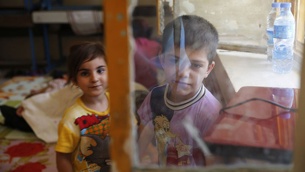 Children of a Christian family, who fled from the violence in Mosul two days ago, stay at a school in Arbil, in Iraq's Kurdistan region June 27, 2014. Iraqi forces launched an airborne assault on rebel-held Tikrit on Thursday with commandos flown into a stadium in helicopters, at least one of which crashed after taking fire from insurgents who have seized northern cities. REUTERS/Ahmed Jadallah (IRAQ - Tags: CIVIL UNREST POLITICS CONFLICT SOCIETY) - RTR3W0VR