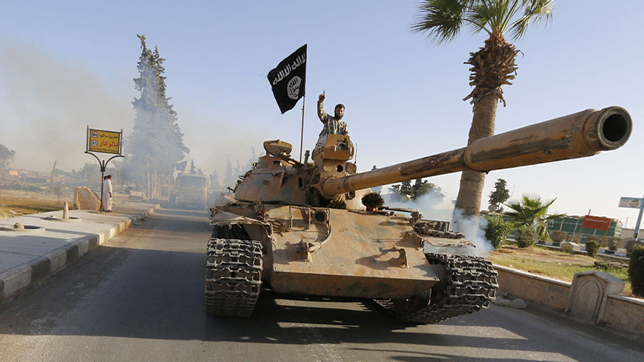 Militant Islamist fighters on a tank take part in a military parade along the streets of northern Raqqa province Militant Islamist fighters on a tank take part in a military parade along the streets of northern Raqqa province June 30, 2014. Militant Islamist fighters held a parade in Syria's northern Raqqa province to celebrate their declaration of an Islamic "caliphate" after the group captured territory in neighbouring Iraq, a monitoring service said. The Islamic State, an al Qaeda offshoot previously known as Islamic State in Iraq and the Levant (ISIL), posted pictures online on Sunday of people waving black flags