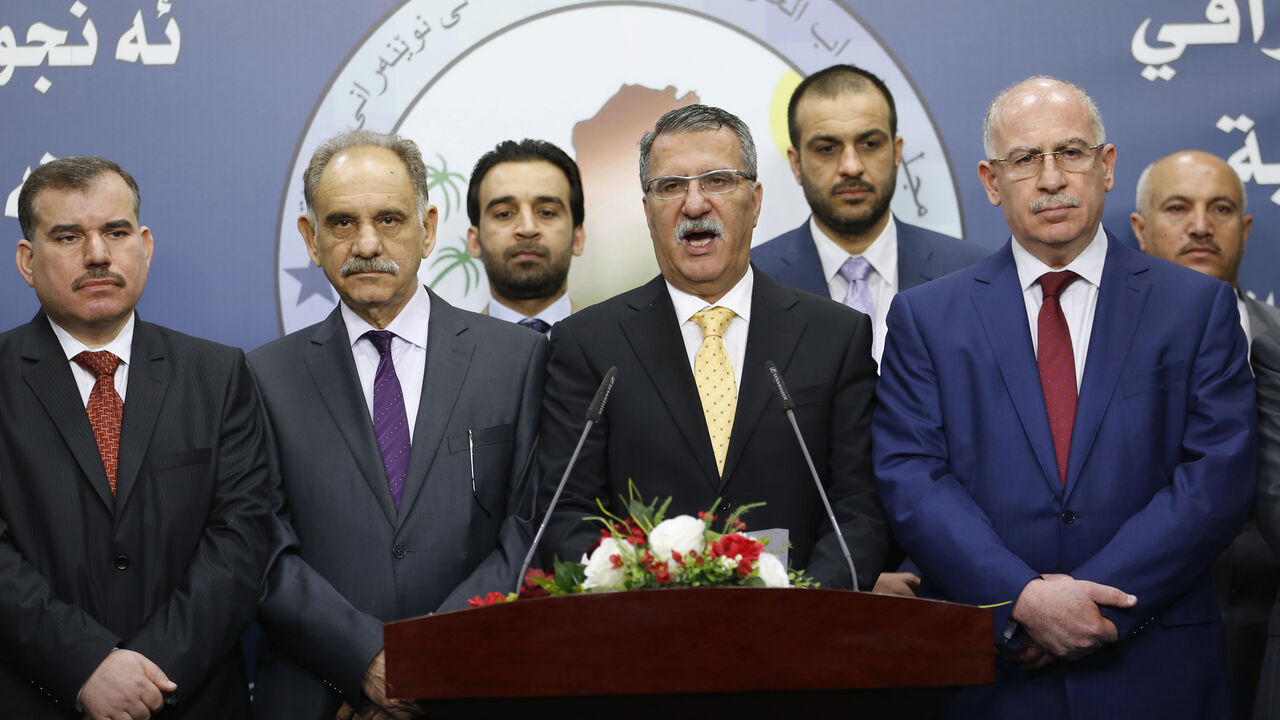 Dhafer al-Ani, a prominent Sunni Arab lawmaker, speaks during a news conference by members of Sunni political bloc Mutahidoon after the first session of the Iraqi Parliament in Baghdad Dhafer al-Ani (C), a prominent Sunni Arab lawmaker, speaks during a news conference by members of Sunni political bloc Mutahidoon after the first session of the Iraqi Parliament in Baghdad, July 1, 2014. Sunnis and Kurds walked out of the first session of Iraq's new parliament on Tuesday after Shi'ites failed to name a prime minister to replace Nuri al-Maliki, dimming any prospect of an early national unity government to save Iraq from collapse. Parliament is not likely to meet again for at least a week, le