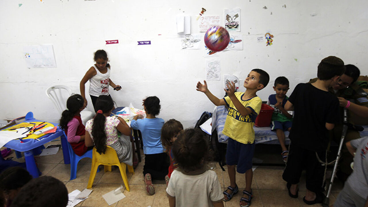Israeli children play inside a bomb shelter in Ashkelon Israeli children play inside a bomb shelter in the southern city of Ashkelon July 10, 2014. At least 74 Palestinians, most of them civilians, have been killed in Israel's Gaza offensive, Palestinian officials said on Thursday, and militants kept up rocket attacks on Tel Aviv and other cities in warfare showing no signs of ending soon. REUTERS/Ronen Zvulun (ISRAEL - Tags: POLITICS CIVIL UNREST SOCIETY) - RTR3Y0MI