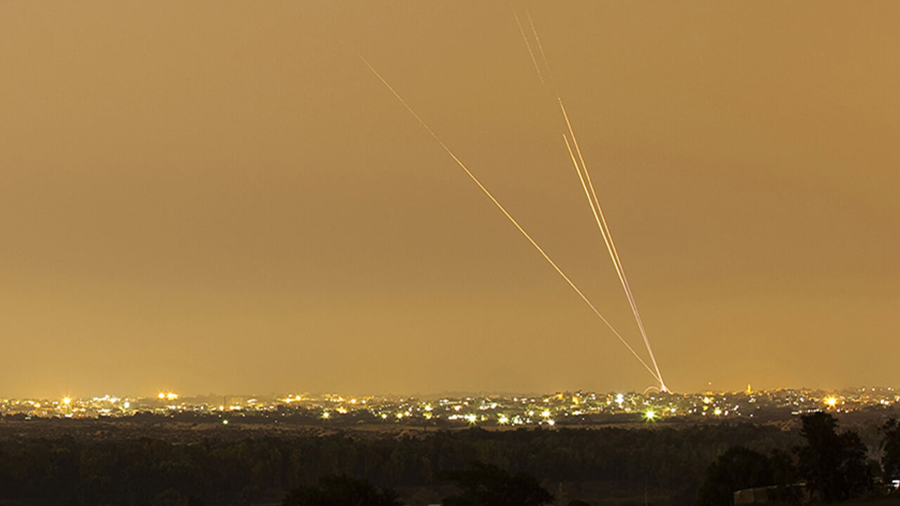 Smoke trails are seen as rockets are launched towards Israel from the northern Gaza Strip July 12, 2014.  Hamas militants launched ten rockets at Tel Aviv on Saturday, causing no casualties or damage, in the largest salvo yet on Israel's main business hub, since Israel launched its Gaza offensive against the Islamist group, five days ago. Picture shot using a long exposure. REUTERS/Amir Cohen (ISRAEL - Tags: POLITICS CIVIL UNREST MILITARY CONFLICT TPX IMAGES OF THE DAY) - RTR3YB6I