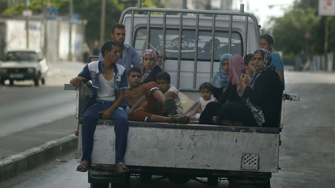 Palestinians, who fled their homes that are adjacent to the border with Israel, ride in a truck as they make their way to stay in a United Nations-run school in Gaza City Palestinians, who fled their homes that are adjacent to the border with Israel, ride in a truck as they make their way to stay in a United Nations-run school in Gaza City July 13, 2014. An Israeli air strike on the home of Gaza's police chief killed 18 people on Saturday, Gaza's health ministry said, and Hamas fired the largest salvo of rockets yet on Tel Aviv since the start of the Jewish state's offensive in the Palestinian enclave. Israel's offensive has killed 145 Palestinians since Tuesday. Gaza medica