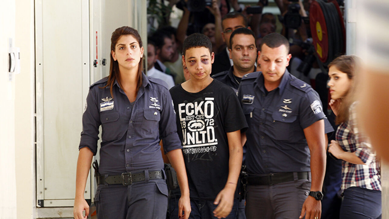 PALESTINIANS-ISRAEL/INVESTIGATION Tariq Khdeir (C), a 15-year-old American of Palestinian descent and a cousin of Mohammed Abu-Khdeir, the youth whom Palestinians believe was abducted and murdered by far-right Israelis on Wednesday, is escorted by Israeli prison guards during an appearance at Jerusalem magistrate's court July 6, 2014. The United States called for speedy investigation of an incident in which Khdeir appeared to have been badly beaten by Israeli paramilitary police during riots in East Jerusalem. A police spokesman said Khdeir