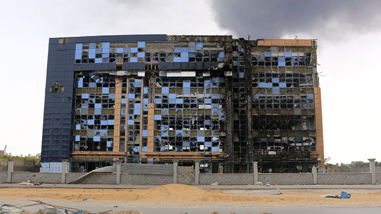 A damaged building is pictured after clashes between rival militias, in an area at Alswani road in Tripoli A damaged building is pictured after clashes between rival militias, in an area at Alswani road in Tripoli July 28, 2014. A rocket hit a fuel storage tank in a chaotic battle for Tripoli airport that has all but closed off international flights to Libya, leaving fire-fighters struggling to extinguish a giant conflagration. Two rival brigades of former rebels fighting for control of Tripoli International Airport have pounded each other's positions with Grad rockets, artillery fire and cannons for two weeks,