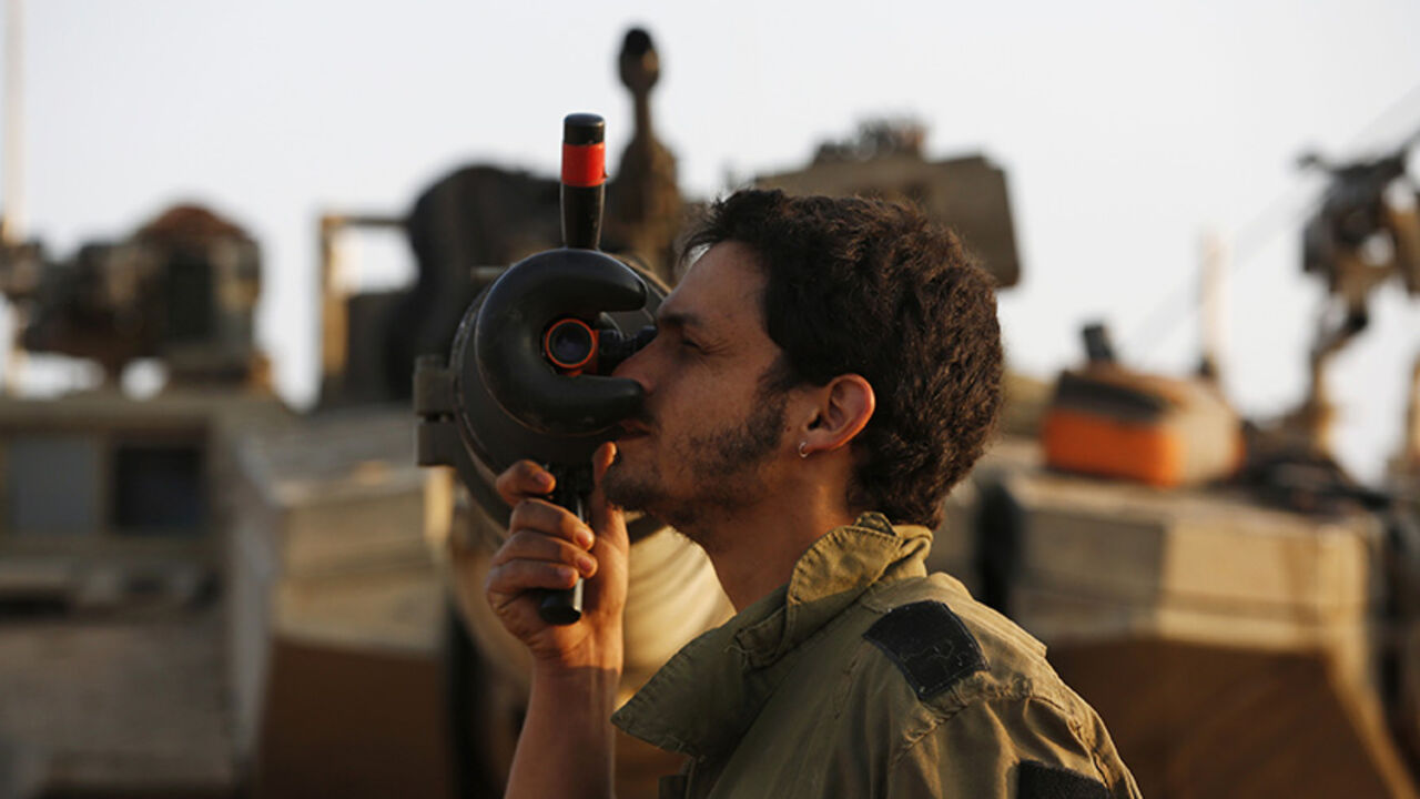 An Israeli soldier adjusts sights on a tank outside the northern Gaza Strip An Israeli soldier adjusts sights on a tank at a staging area outside the northern Gaza Strip July 29, 2014. Israel's military pounded targets in the Gaza Strip on Tuesday after Prime Minister Benjamin Netanyahu said his country should prepare for a long conflict in the Palestinian enclave, squashing any hopes of a swift end to 22 days of fighting. Israel launched its offensive on July 8 with the aim of halting rocket attacks by Hamas and its allies. It later ordered a land invasion to find and destroy the