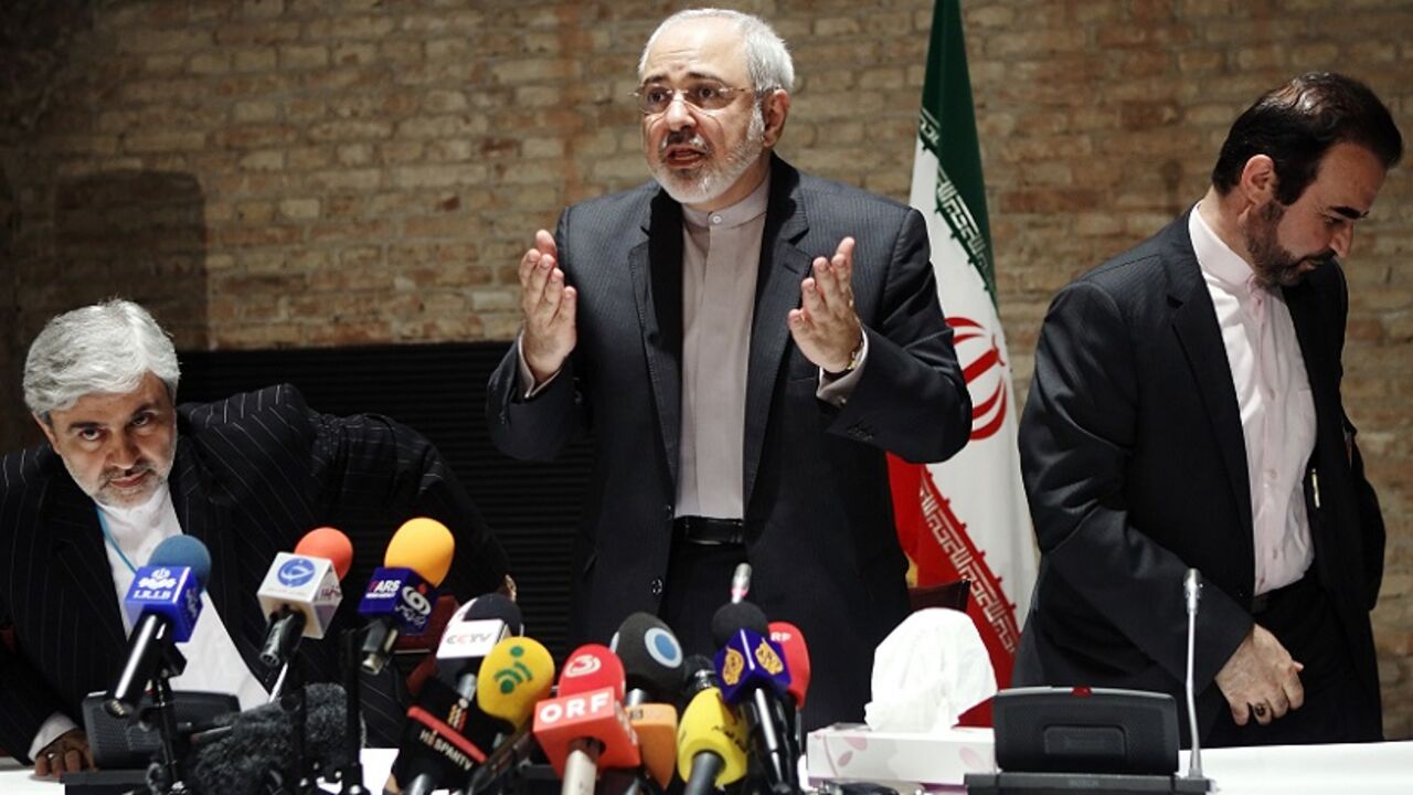 Iranian Foreign Minister Mohammad Javad Zarif and diplomats leave a news conference in Vienna Iranian Foreign Minister Mohammad Javad Zarif (C) and diplomats leave a news conference in Vienna July 15, 2014. Zarif suggested on Tuesday that six world powers are leaning towards extending nuclear talks with Tehran beyond a July 20 deadline although both sides still hoped to reach an agreement over the next five days. REUTERS/Heinz-Peter Bader (AUSTRIA - Tags: POLITICS ENERGY) - RTR3YRRR