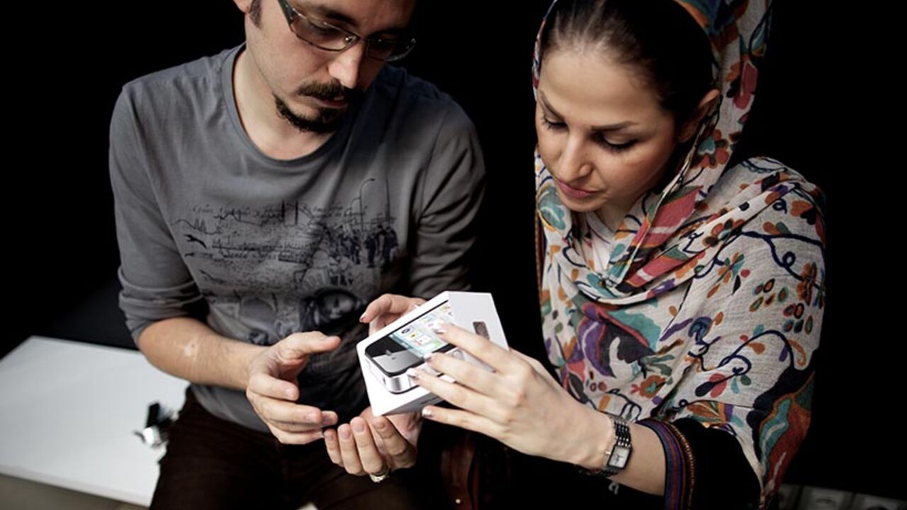 IRAN-US-INTERNET-SANCTIONS TO GO WITH AFP STORY BY MOHAMMAD DAVARI
An Iranian couple inpect the box of an IPhone they just bought at a computer shop selling Apple products in northern Tehran on June 1, 2013. The United States lifted a ban on sales of communications equipment to Iranians and opened access to Internet services and social media, in a bid to help the Iranian people avoid government controls. The US State Department said the action will allow Iranians to skirt "attempts to silence its people by cutting off their communic