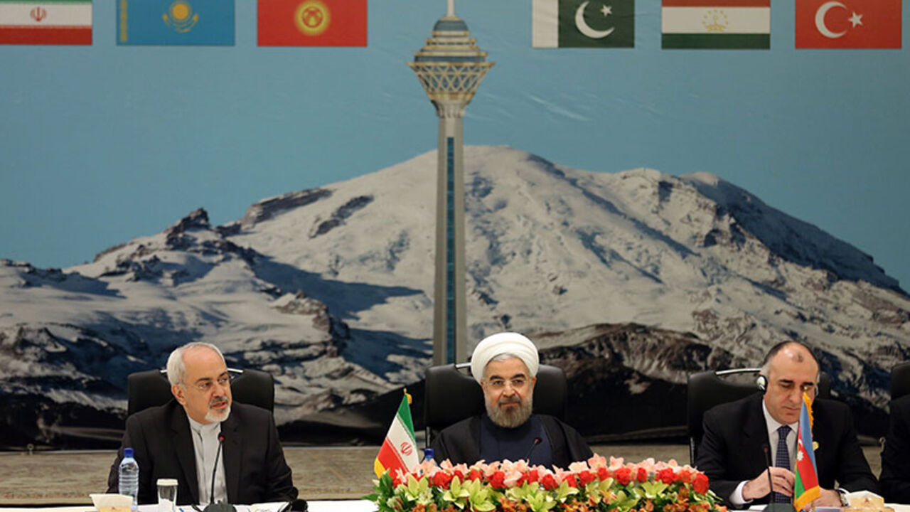IRAN-POLITICS-ECONOMY Seated between Iranian Foreign Minister Mohammad Javad Zarif (L) and Azerbaijan's Foreign Minister Elmar Mammadyarov (R), the Islamic republic's President Hassan Rouhani opens a two-day ministerial conference of the Economic Cooperation Organisation (ECO), which groups 10 Asian and Eurasian countries, in Tehran on November 26, 2013. AFP PHOTO / ATTA KENARE (Photo credit should read ATTA KENARE/AFP/Getty Images)