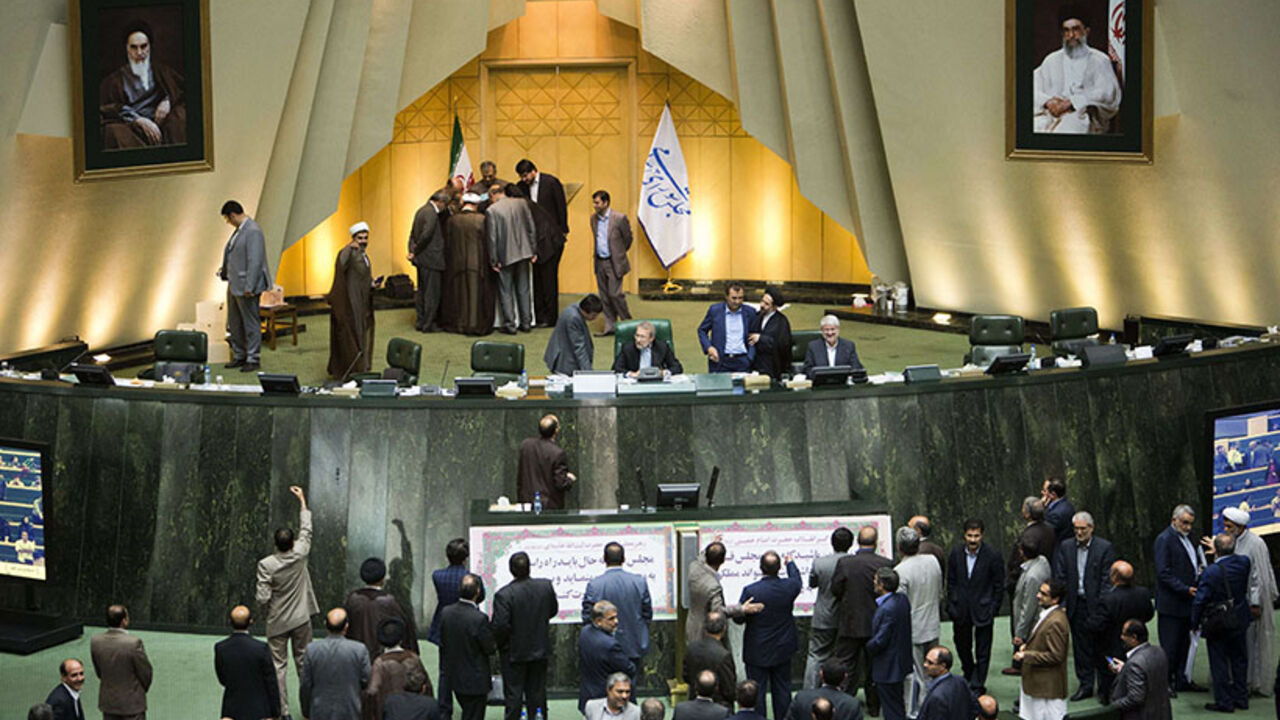 IRAN-POLITICS-PARLIAMENT-CABINET Iranian MPs wait for the results of impeachment of Minister for Science, Research and Technology, Reza Faraji Dana as other MPs (top L) count the ballots after voting at parliament in Tehran on August 20, 2014. Iran's conservative-dominated parliament voted to sack the science minister for wanting to recruit people accused of involvement in the 2009 protest movement. AFP PHOTO/BEHROUZ MEHRI (Photo credit should read BEHROUZ MEHRI/AFP/Getty Images)