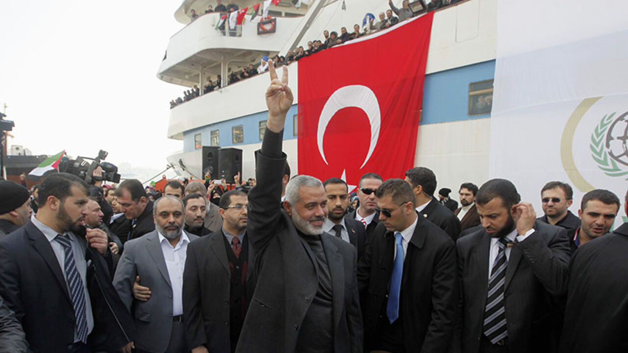 Hamas' Gaza leader Haniyeh flashes a victory sign to his supporters in front of the cruise liner Mavi Marmara in Istanbul Hamas' Gaza leader Ismail Haniyeh (C) flashes a victory sign to his supporters in front of the cruise liner Mavi Marmara in Istanbul January 2, 2012. REUTERS/Osman Orsal (TURKEY - Tags: POLITICS TRANSPORT TPX IMAGES OF THE DAY) - RTR2VT9X