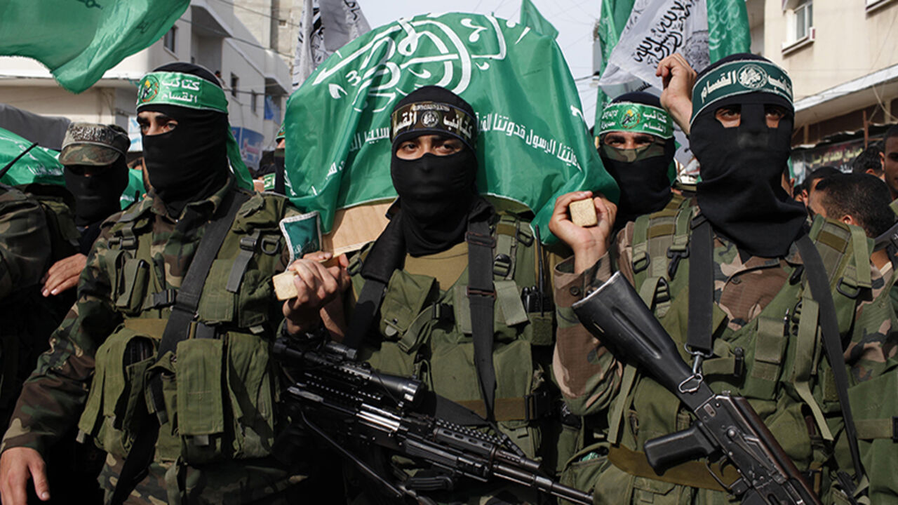 Palestinian Hamas militants carry a coffin containing the body of their comrade Rami Meshmish during his funeral in the central Gaza Strip Palestinian Hamas militants carry a coffin containing the body of their comrade Rami Meshmish during his funeral in the central Gaza Strip April 16, 2014. Meshmish and another fellow militant were killed in an accidental explosion on Wednesday; al-Qassam brigades, the armed wing of Hamas movement, said in a statement. REUTERS/Ibraheem Abu Mustafa (GAZA - Tags: POLITICS) - RTR3LJJR