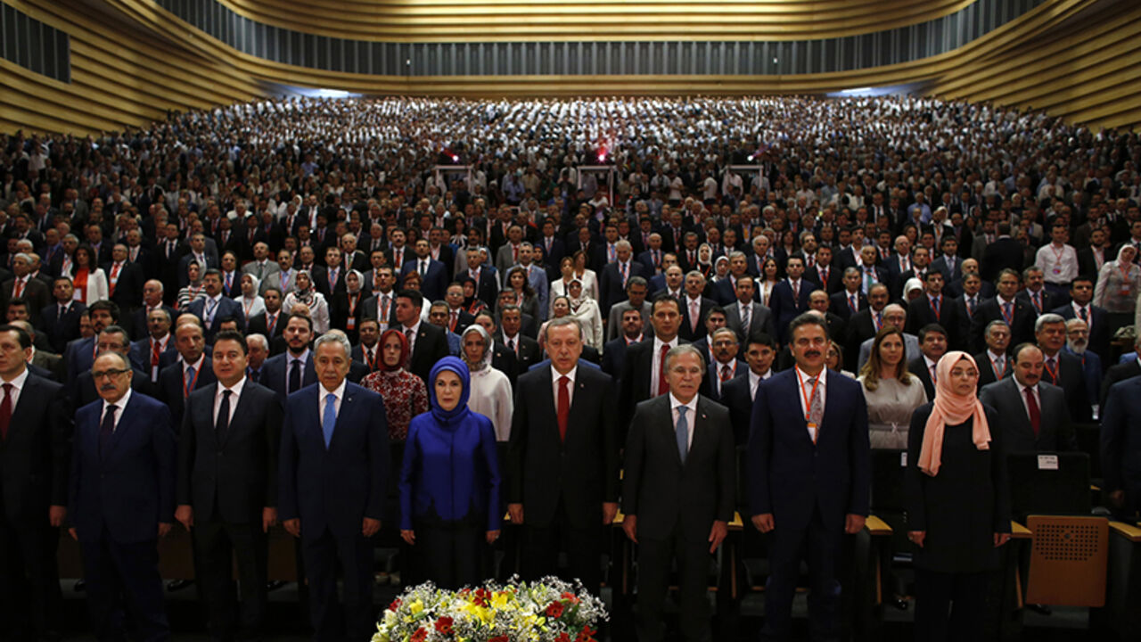 Turkey's Prime Minister Tayyip Erdogan (C), his family and AK Party (AKP) members attend a meeting where he is named as his party's candidate for the country's first direct presidential election in Ankara July 1, 2014. Tayyip Erdogan declared his candidacy on Tuesday for a more powerful presidency which rivals fear may entrench authoritarian rule and supporters, especially conservative Muslims, see as the crowning prize in his drive to reshape NATO member Turkey. REUTERS/Umit Bektas (TURKEY - Tags: POLITICS