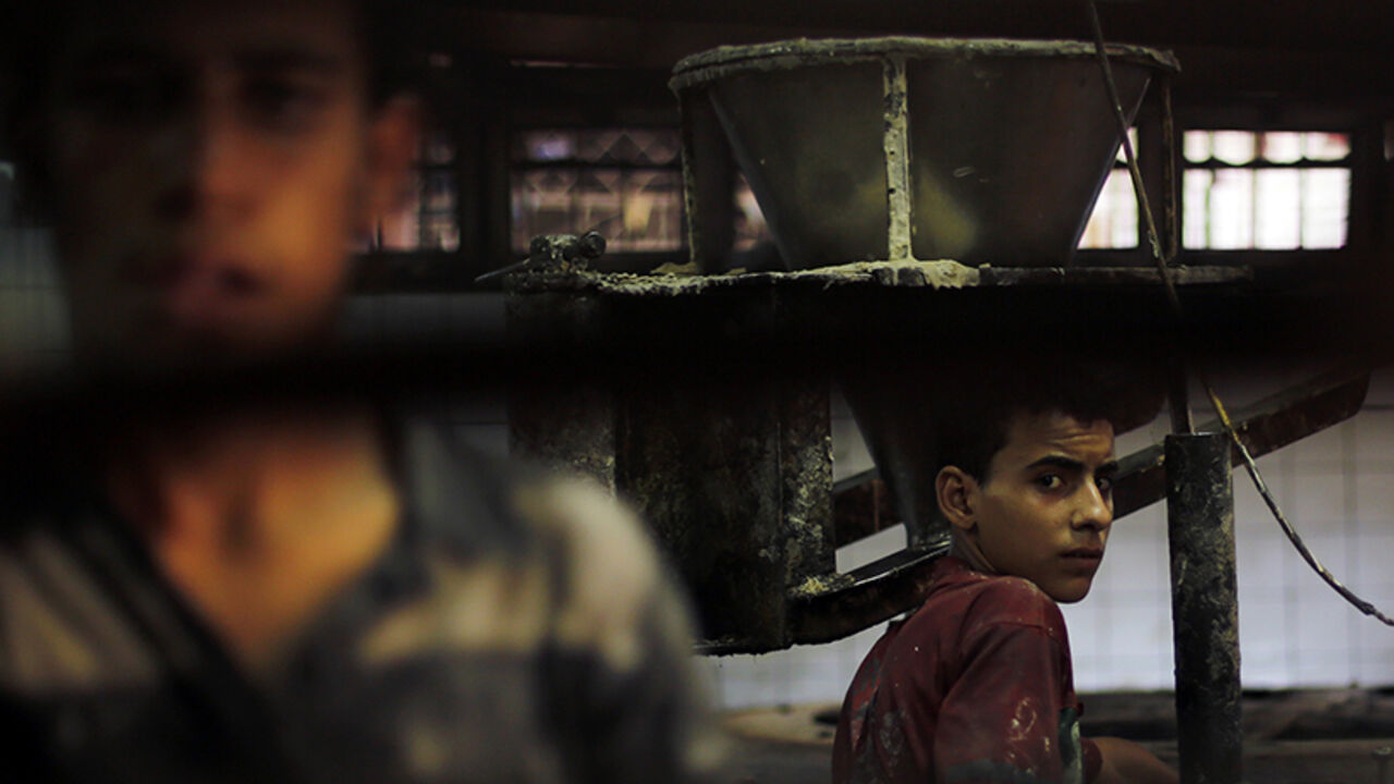 Employees work on dough for kunafa at a machine in the factory of Arafah Al Kanafani, a shop selling traditional sweets, in old Cairo Employees work on dough for kunafa at a machine in the factory of Arafah Al Kanafani, a shop selling traditional sweets, in old Cairo July 9, 2014. Arafah, which started operations in 1870, is one of the oldest pastry shops in Egypt that sells traditional desserts such as kunafa and qatayef during the holy fasting month of Ramadan, according to the owner Haj Mahmoud Arafah, who is from the Arafah family that founded the shop. REUTERS/Amr Abdallah Dalsh (EGYPT - Tags: RELIGION SOCIETY FOOD BUSINESS) - RTR3XU