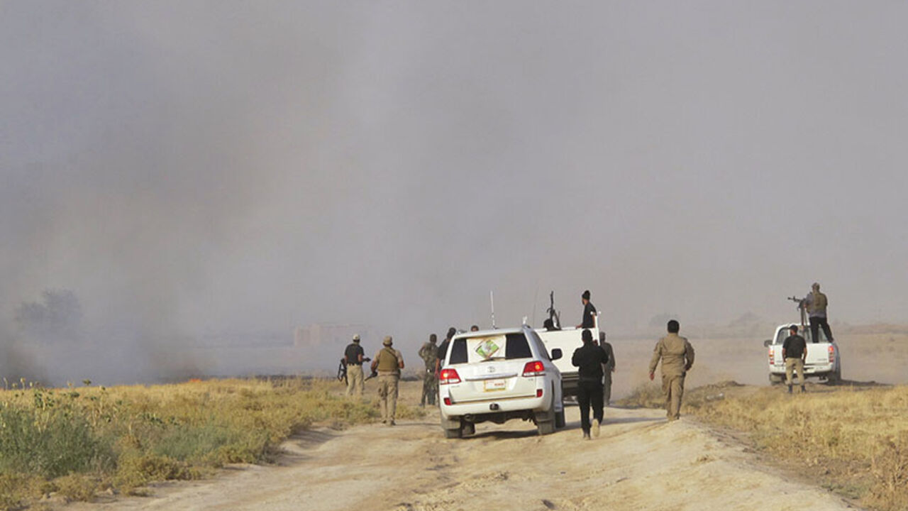 Shi'ite volunteers from Mehdi Army loyal to radical cleric Muqtada al-Sadr, patrol in vehicles, as smoke rises from clashes with Islamic State fighters, on outskirts of Tikrit Shi'ite volunteers from the Mehdi Army loyal to radical cleric Muqtada al-Sadr, patrol in vehicles, as smoke rises from clashes with Islamic State fighters, on the outskirts of Tikrit, July 20, 2014. Iraqi troops and Shi'ite militants patrolled areas of Tikrit as they launched an assault to retake the city currently held by Islamic State fighters. REUTERS/Stringer (IRAQ - Tags - Tags: CIVIL UNREST POLITICS MILITARY) - RTR3ZG0I