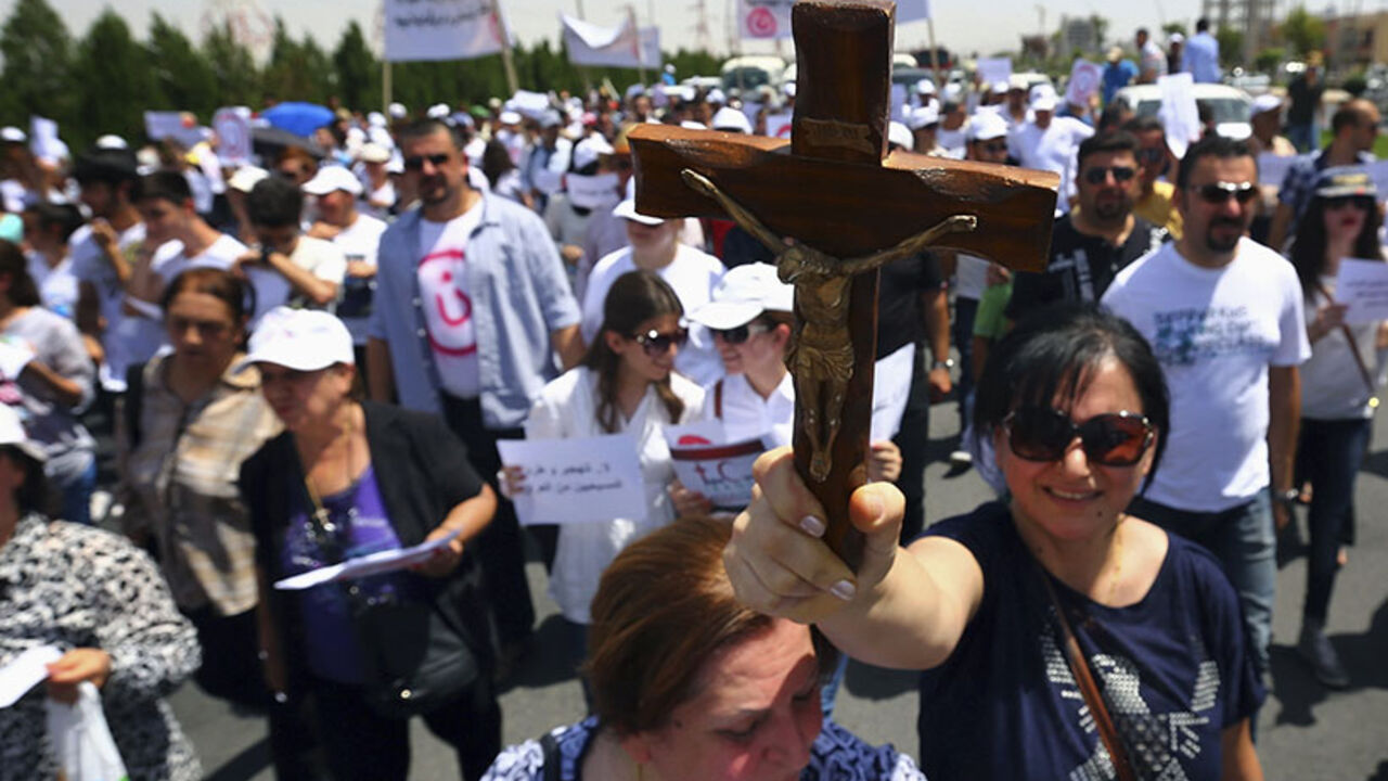 A Christian woman carries a cross during a demonstration against militants of the Islamic State, formerly known as ISIL, in Arbil, north of Baghdad A Christian woman carries a cross during a demonstration against militants of the Islamic State, formerly known as the Islamic State in Iraq and the Levant (ISIL), in Arbil, north of Baghdad July 24, 2014. Hundreds of Iraqi Christians marched to the United Nations office in Arbil city on Thursday calling for help for families who fled in the face of threats by Islamic State militants. REUTERS/Stringer (IRAQ - Tags: CIVIL UNREST POLITICS TPX IMAGES OF THE DAY) - RTR400H7