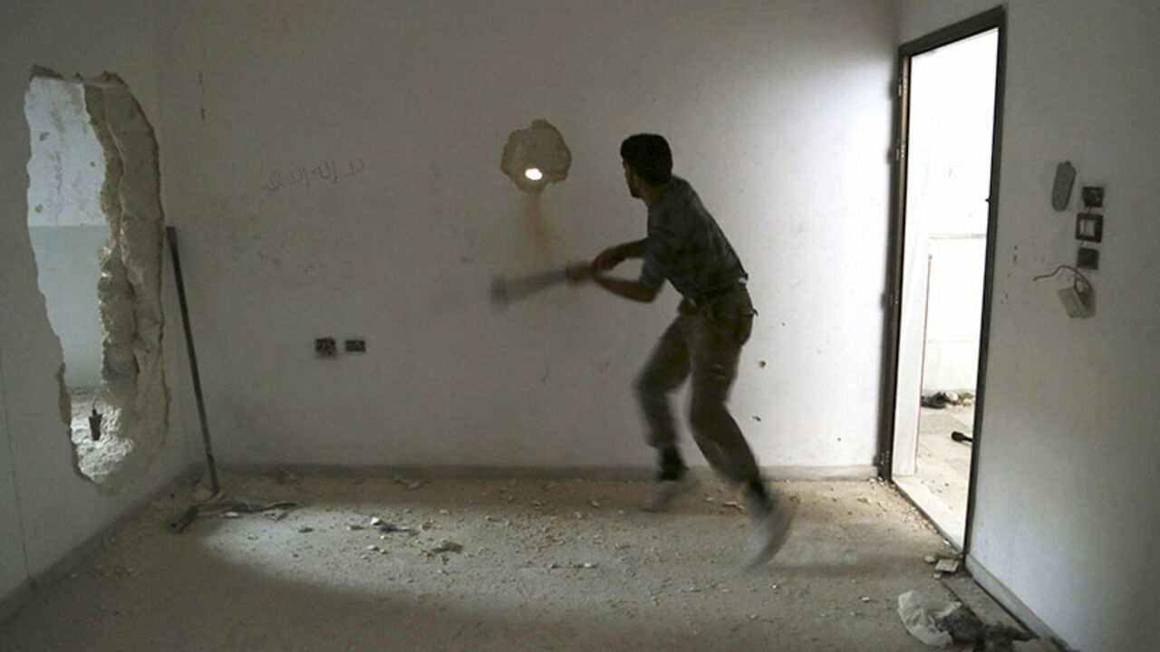 A rebel fighter knocks a hole in a wall inside a room at Karm al-Tarab frontline in Aleppo A rebel fighter knocks a hole in a wall inside a room at Karm al-Tarab frontline in Aleppo July 30, 2014. Picture taken July 30, 2014. REUTERS/Hamid Khatib (SYRIA - Tags: POLITICS CONFLICT) - RTR40SK6