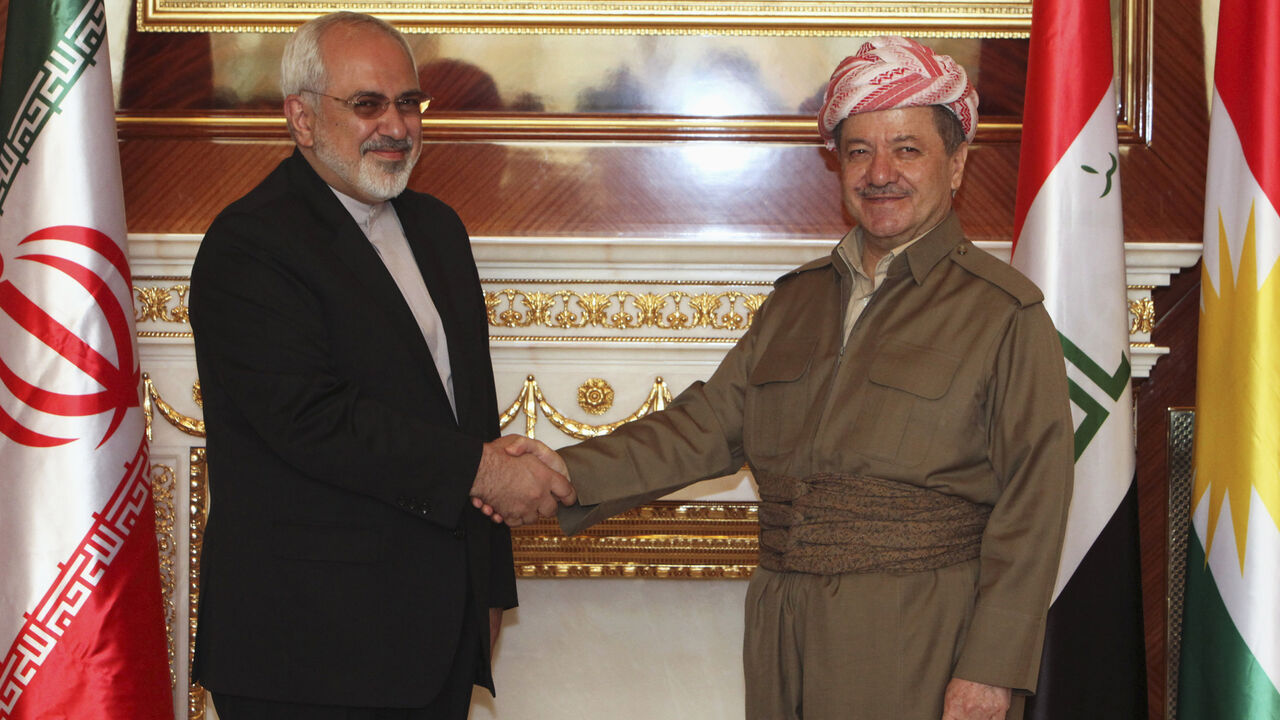 Iraqi Kurdish regional President Barzani shakes hands with Iranian foreign minister Zarif in Arbil Iraqi Kurdish regional President Masoud Barzani (R) shakes hands with Iranian foreign minister Mohammad Javad Zarif in Arbil, north of Baghdad, August 26, 2014. Iran supplied weapons and ammunition to Iraqi Kurdish forces, Kurdistan President Barzani said Tuesday at a joint news conference with Iranian foreign minister Zarif in Arbil, capital of Iraq's autonomous Kurdish region. REUTERS/Azad Lashkari (IRAQ - Tags: POLITICS CONFLICT CIVIL UNREST TPX IMAGES OF THE DAY) - RTR43TA5