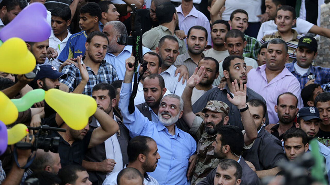 Hamas Gaza leader Ismail Haniyeh holds a gun as he appears for the first time since the start of a seven-week conflict during a rally by Palestinians celebrating what they said was a victory over Israel, in Gaza City Hamas Gaza leader Ismail Haniyeh holds a gun as he appears for the first time since the start of a seven-week conflict during a rally by Palestinians celebrating what they said was a victory over Israel, in Gaza City August 27, 2014. An open-ended ceasefire in the Gaza war held on Wednesday as Prime Minister Benjamin Netanyahu faced strong criticism in Israel over a costly conflict with Palestinian militants in which no clear victor emerged. REUTERS/Suhaib Salem (GAZA - Tags: POLITICS CIVIL UNREST CONFLICT