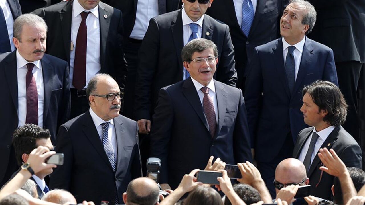 Turkish Prime Minister Ahmet Davutoglu greets his supporters as he leaves Kocatepe Mosque after Friday prayers in Ankara Turkish Prime Minister Ahmet Davutoglu greets his supporters as he leaves Kocatepe Mosque after Friday prayers in Ankara August 29, 2014. Davutoglu announced a new cabinet on Friday keeping key members of the economic management team in place and appointing the man who has managed Ankara's affairs with Europe as foreign minister. REUTERS/Umit Bektas (TURKEY - Tags: POLITICS) - RTR448EI