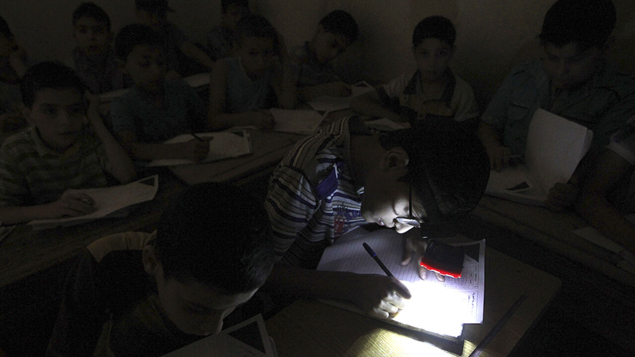 A student wears a headlight, due to electricity shortage, as he takes his year-end examinations at a school in Aleppo's al-Sha'ar district A student wears a headlight, due to electricity shortage, as he takes his year-end examinations at a school in Aleppo's al-Sha'ar district June 5, 2013. REUTERS/Muzaffar Salman (SYRIA - Tags: CONFLICT EDUCATION SOCIETY) - RTX10CK8