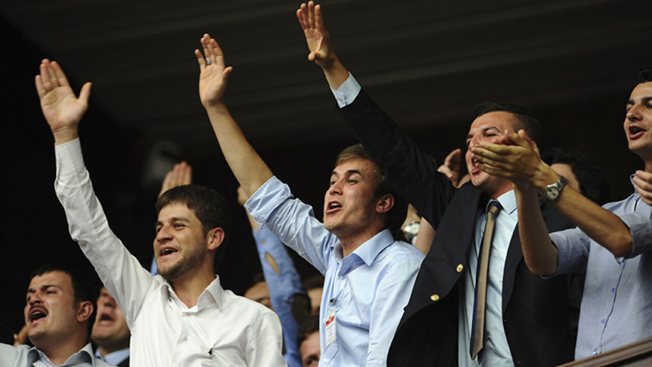 Supporters of Turkey's PM Erdogan cheer as he addresses the members of parliament from his ruling AK Party during a meeting at the Turkish parliament in Ankara Supporters of Turkey's Prime Minister Tayyip Erdogan (not pictured) cheer as he addresses the members of parliament from his ruling AK Party (AKP) during a meeting at the Turkish parliament in Ankara June 18, 2013. REUTERS/Stringer (TURKEY - Tags: POLITICS) - RTX10RT1