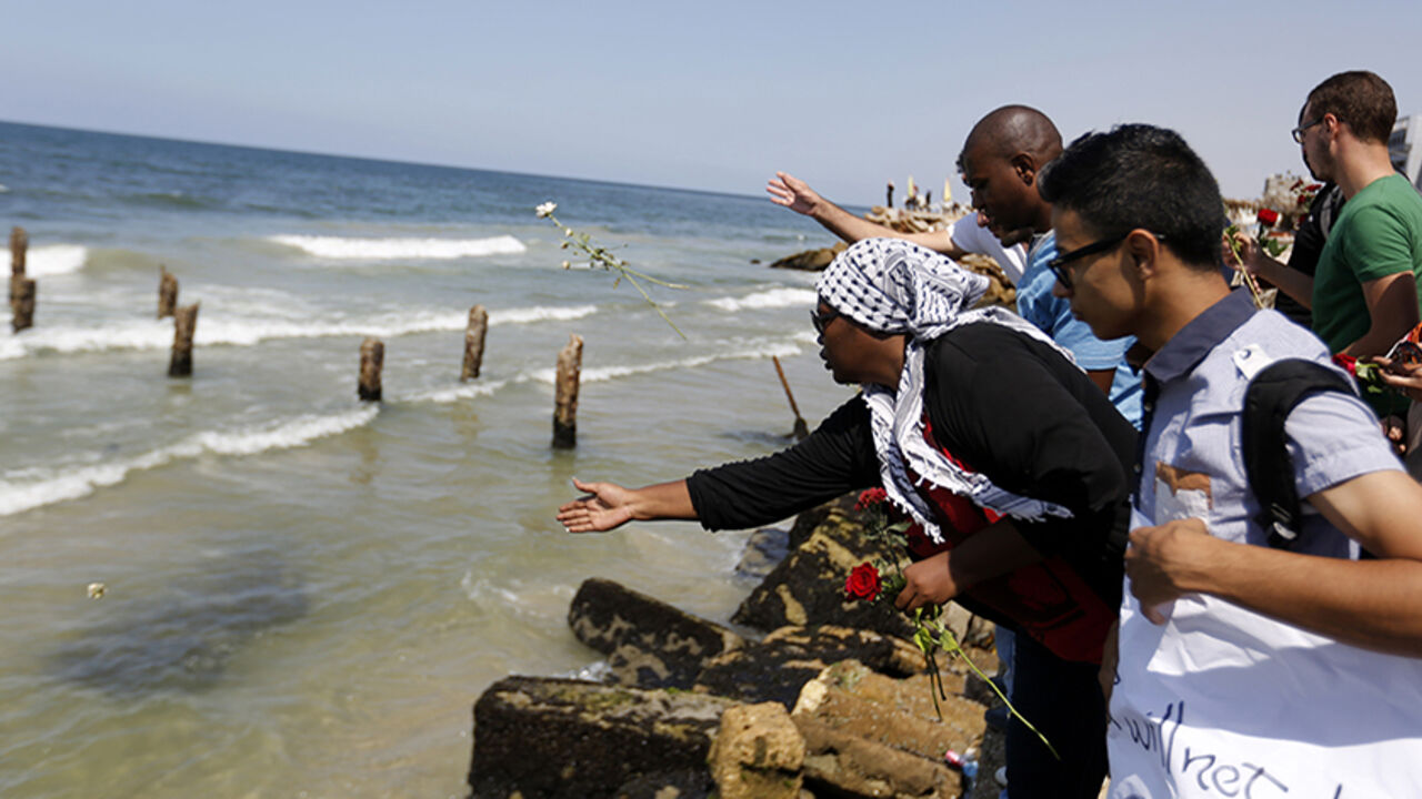 PALESTINIAN-ISRAEL-CONFLICT-GAZA-BOAT-IMMIGRATION Palestinians throw roses in the Mediterranean sea off the coast of Gaza City on September 18, 2014 in mourning over the loss of fellow Palestinians who had boarded a boat to Europe that sank off Malta last week. In one of the deadliest migrant shipwrecks on record, the boat, with 500 people on board, was intentionally capsized by traffickers as it made its way from Egypt to Italy. Only 10 people are known to have survived, among them four Palestinians from the 100 Gazans believed to have been on board. AFP
