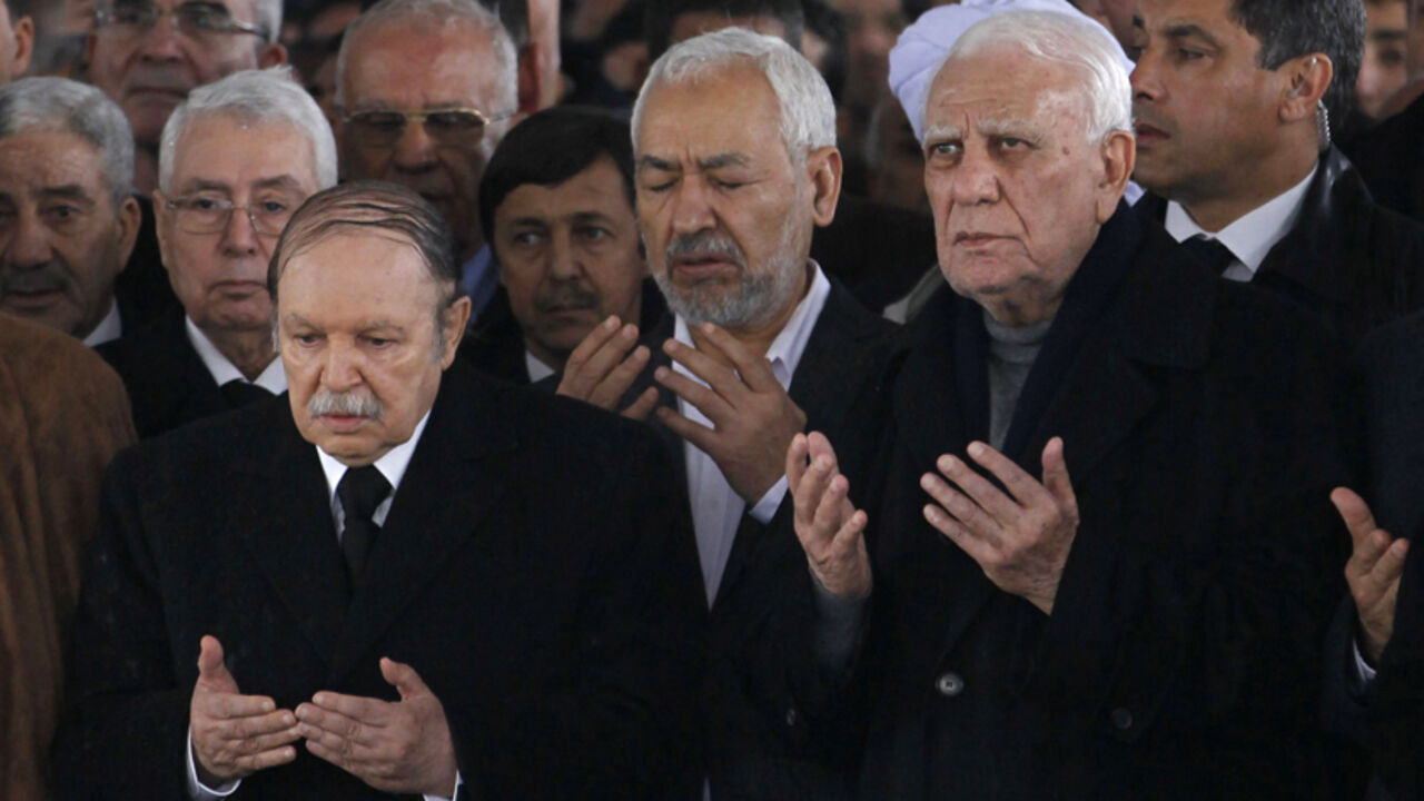 Algerian President Bouteflika, Algerian former President Bendjedid and leader of the Islamist Ennahda movement Ghannouchi attend funeral of the first President of independent Algeria Ben Bella in Algiers Algerian President Abdelaziz Bouteflika (L), Algerian former President Chadli Bendjedid (R) and leader of the Islamist Ennahda movement Rached Ghannouchi (C) pray during the funeral of the first President of independent Algeria Ahmed Ben Bella at Al Alia Cemetery in Algiers April 13, 2012. Ahmed Ben Bella helped lead Algeria's fight for independence from France and after victory became its first president, a figure who symbolised the romance of the national liberation struggle before the harsh reality of ru