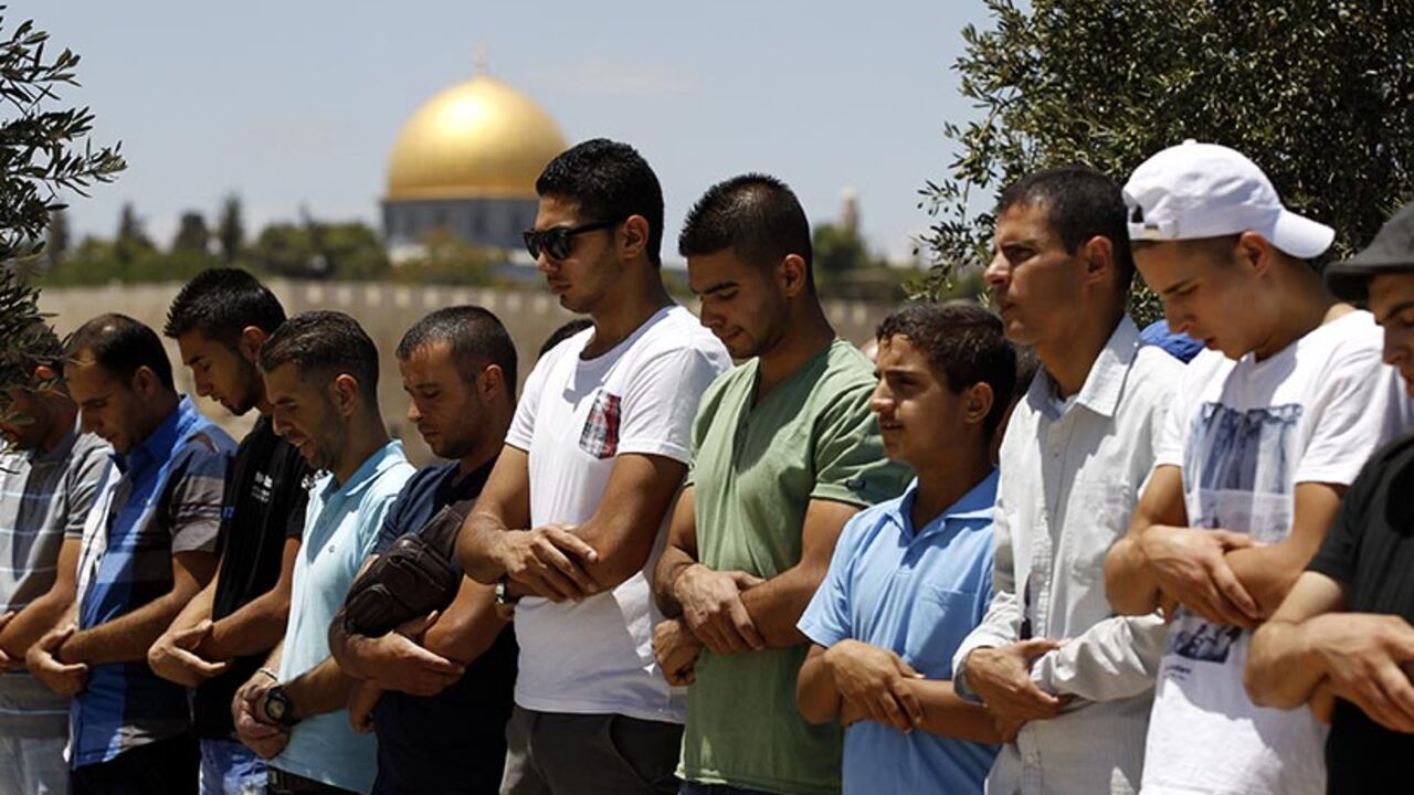 The Dome of the Rock is seen in the background as Palestinians pray on the third Friday of the holy month of Ramadan in Arab east Jerusalem The Dome of the Rock is seen in the background as Palestinians pray on the third Friday of the holy month of Ramadan in the Arab east Jerusalem neighbourhood of Ras al-Amud July 18, 2014. An Israeli police spokesman said on Friday that police allowed only Palestinian men over the age of 50 to enter a compound which houses Al-Aqsa mosque and is known to Muslims as Noble Sanctuary and to Jews as Temple Mount in Jerusalem's Old City. He added that seven people were detained on suspicion of throwing stones at p