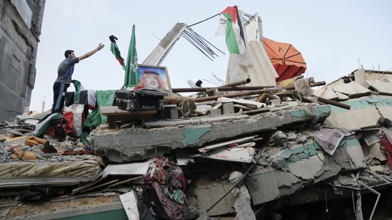 A Palestinian man throws a flag atop the rubble of the home of Hamas Gaza leader Ismail Haniyeh in Gaza City A Palestinian man throws a flag atop the rubble of the home of Hamas Gaza leader Ismail Haniyeh, which Gaza's interior ministry said was hit by a missile fired by Israeli aircraft before dawn on Tuesday, causing damage but no casualties, in Gaza City July 29, 2014. Israel's military pounded targets in the Gaza Strip on Tuesday after Prime Minister Benjamin Netanyahu said his country needed to be prepared for a long conflict in the Palestinian enclave, squashing any hopes of a swift end to 22 days of fightin