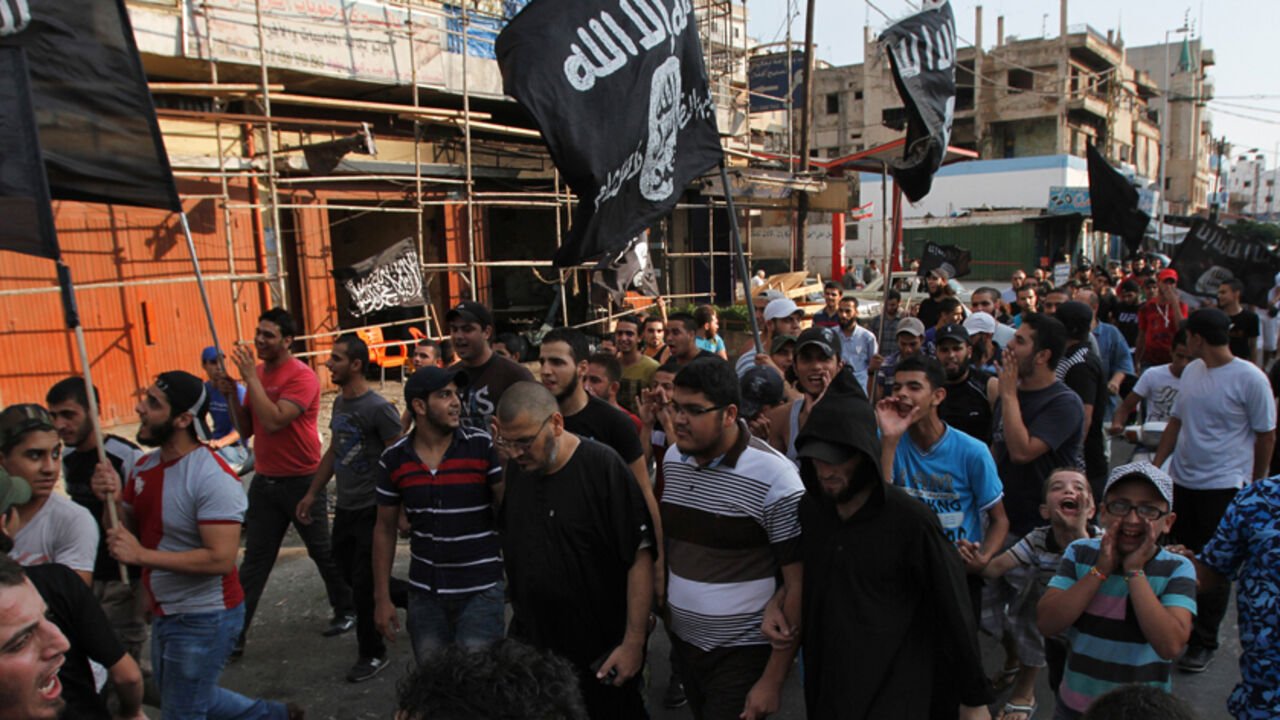Lebanese Sunni Islamist shouts slogans and wave flags as they march during a protest in Tripoli, northern Lebanon Lebanese Sunni Islamist shouts slogans and wave flags as they march during a protest in Tripoli, northern Lebanon, August 4, 2014, condemning the Lebanese army for bombarding Arsal. The Lebanese army advanced on Monday into a border town attacked by Islamists at the weekend in the most serious spillover of the three-year-old Syrian civil war into Lebanon, and the Beirut government said the deadly assault would not go unpunished. REUTERS/Omar Ibrahim (LEBANON - Tags: POLITICS CIVIL UNREST) - RTR417HT