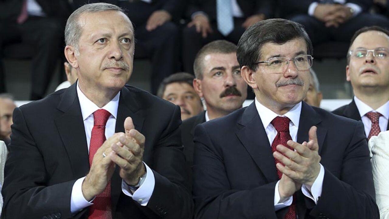 Turkey's Prime Minister Tayyip Erdogan and Foreign Minister Ahmet Davutoglu applaud during the Extraordinary Congress of AKP in Ankara Turkey's Prime Minister Tayyip Erdogan (L) and Foreign Minister Ahmet Davutoglu applaud during the Extraordinary Congress of the ruling AK Party (AKP) to choose a new leader of the party, ahead of Erdogan's inauguration as president, in Ankara August 27, 2014. Turkish president-elect Erdogan said on Wednesday he would ask incoming prime minister Ahmet Davutoglu to form a new government on Thursday, and a new cabinet of ministers would be announced the following day. REUTERS/Rasit Aydogan/Pool (TURKEY - T