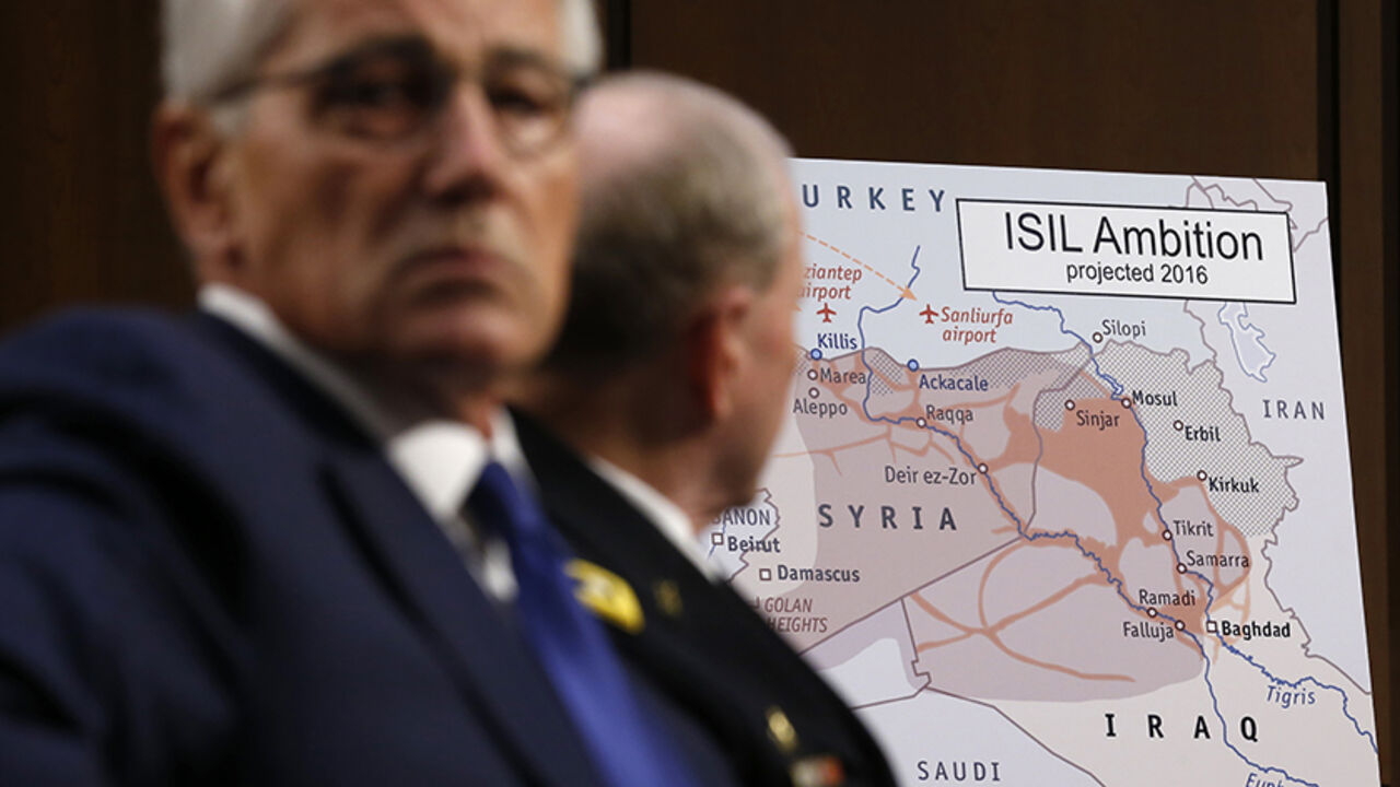 Hagel and Dempsey testify at a hearing about the IS on Capitol Hill in Washington U.S. Secretary of Defense Chuck Hagel (L) and Chairman of the Joint Chiefs of Staff Gen. Martin Dempsey look at a map showing Islamic State ambition as they testify during the Senate Armed Services Committee hearing on U.S. policy toward Iraq and Syria and the threat posed by the Islamic State on Capitol Hill in Washington September 16, 2014. REUTERS/Kevin Lamarque (UNITED STATES - Tags: POLITICS MILITARY) - RTR46G9S
