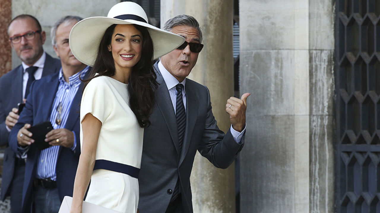 U.S. actor George Clooney and his wife Amal Alamuddin arrive at Venice city hall for a civil ceremony to formalize their wedding in Venice U.S. actor George Clooney and his wife Amal Alamuddin arrive at Venice city hall for a civil ceremony to formalize their wedding in Venice September 29, 2014. REUTERS/Alessandro Bianchi (ITALY - Tags: ENTERTAINMENT) - RTR485U1