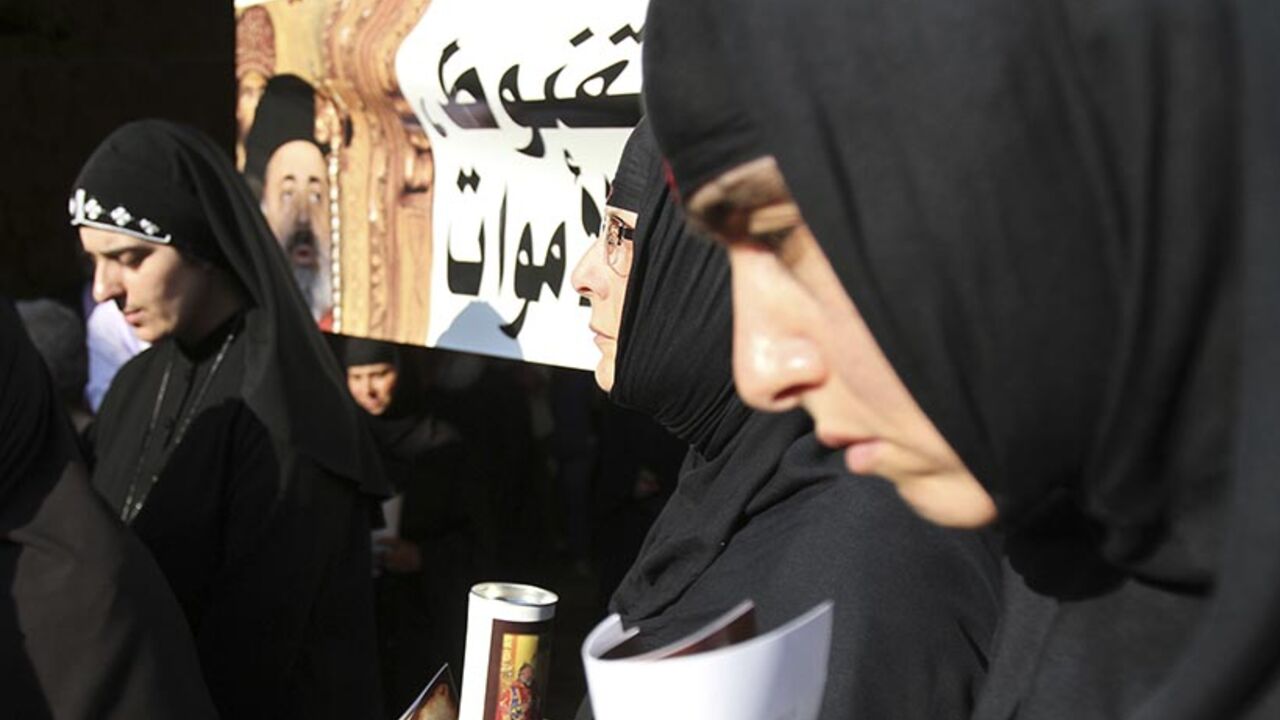 Nuns hold candles during a candle-lit vigil at the Balamand Monastery in Koura, to call for the release of bishops kidnapped in Syria Nuns hold candles during a candle-lit vigil at the Balamand Monastery in Koura, near the north Lebanese city of Tripoli, to call for the release of bishops kidnapped in northern Syria two months ago, June 22, 2013. Greek Orthodox Patriarch John Yazigi led the candle-lit vigil on Saturday for Greek Orthodox archbishop Paul Yazigi and Syriac Orthodox archbishop Yohanna Ibrahim, appealing to their kidnappers to free them and urging Syrian security forces to do more to win their release. REUTERS/Omar Ibrahim (L