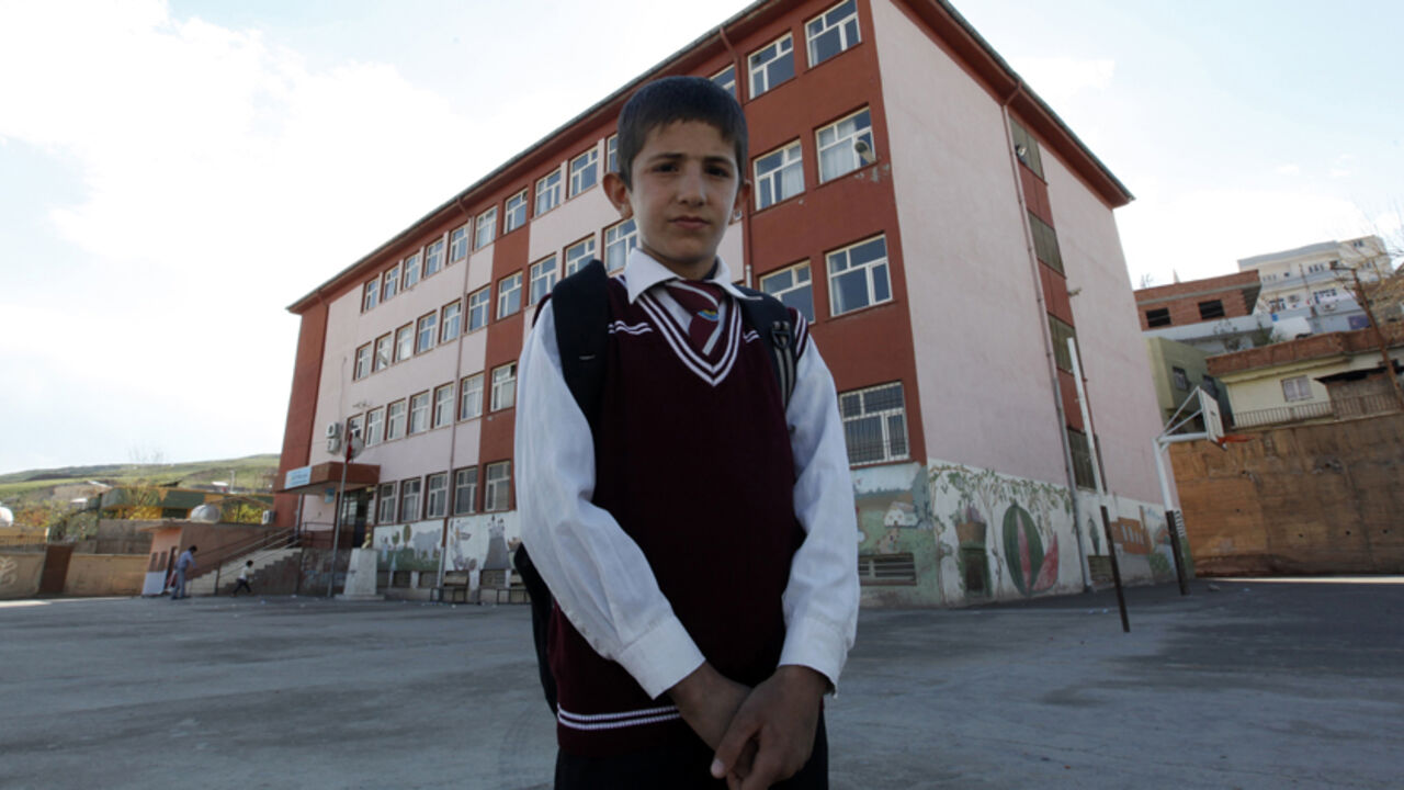 Ferhat Savun poses in front of his school in town of Cizre in Sirnak province Ferhat Savun aged 11, poses in front of his school in the town of Cizre in Sirnak province, near the border with Syria March 24, 2013. Turkey's fledgling peace process with the Kurdistan Workers Party (PKK) militant group is all over the headlines. After three decades of war, 40,000 deaths and a devastating impact on the local economy, everybody seems ready for peace. Pro-Kurdish politicians are focused on boosting minority rights and stronger local government for the Kurds, who make up about 20 percent of