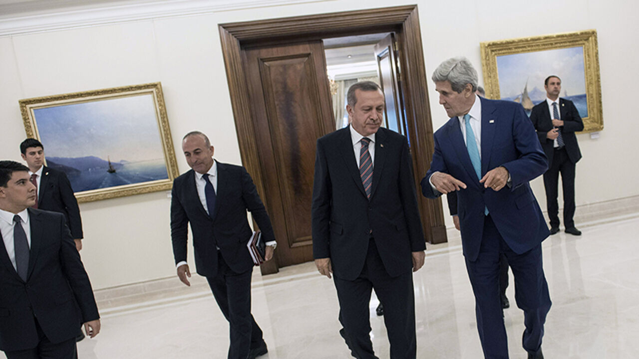 Turkey's President Recep Tayyip Erdogan (C) and U.S. Secretary of State John Kerry (R) leave a meeting at the president's office in Ankara September 12, 2014. Kerry met Turkish leaders on Friday to try to win support for U.S.-led military action against Islamic State, but Ankara's reluctance to play a frontline role showed the difficulty of building a coalition for a regional war.   REUTERS/Brendan Smialowski/Pool (TURKEY - Tags: POLITICS) - RTR460SA