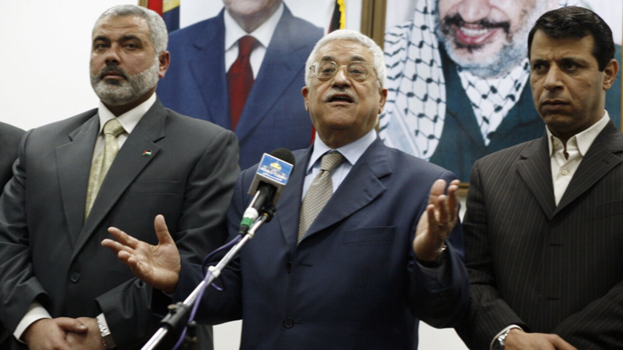 Palestinian President Abbas stands between PM Haniyeh and senior Fatah leader Dahlan in Gaza Palestinian President Mahmoud Abbas (C) stands between Prime Minister Ismail Haniyeh (L) and senior Fatah leader Mohammed Dahlan during the letter of appointment ceremony in Gaza February 15, 2007. Abbas formally asked Haniyeh of Hamas on Thursday to form a new unity government and urged him to abide by peace accords signed with Israel. REUTERS/Suhaib Salem (GAZA) - RTR1MG8Z