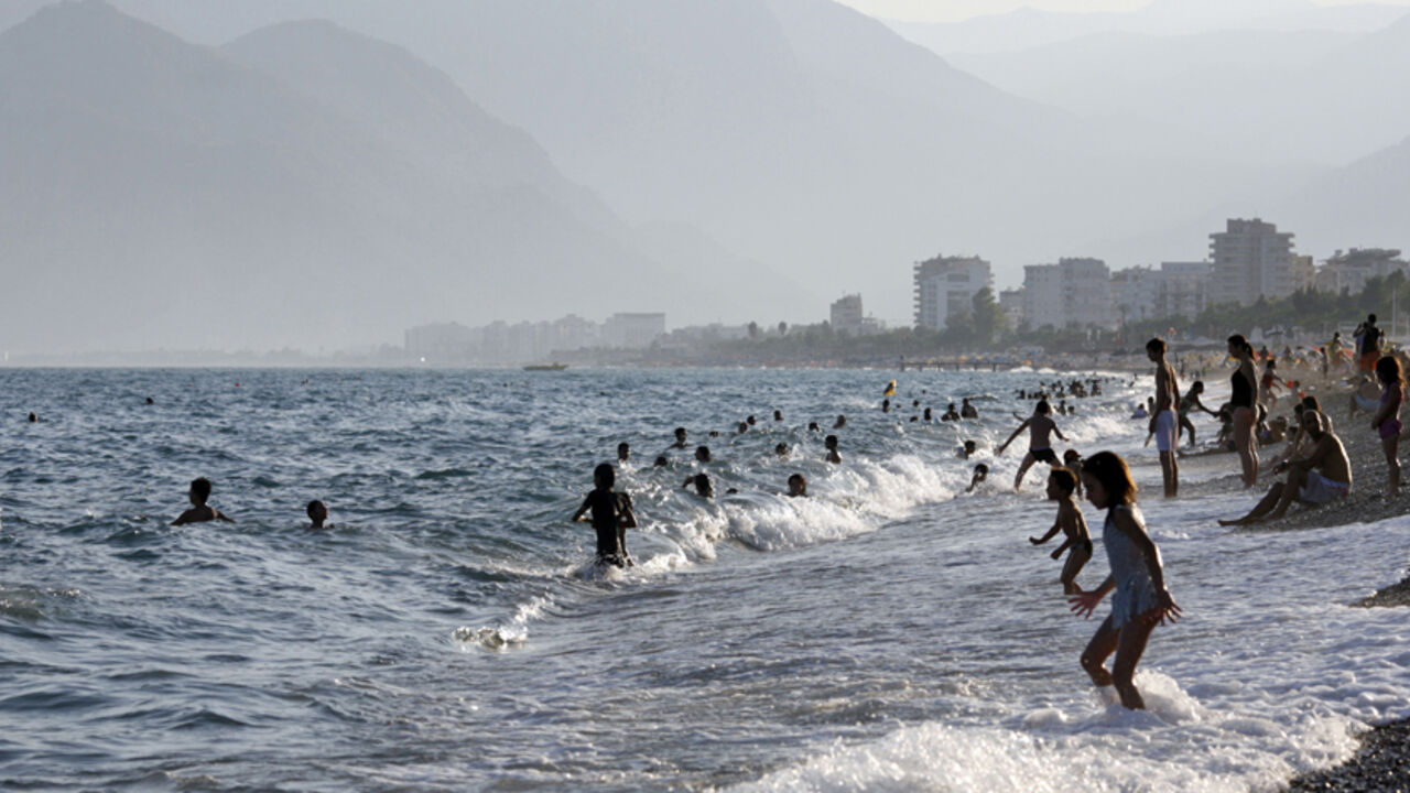 People play on the shore of a beach in the Mediterranean coastal city of Antalya People play on the shore of a beach in the Mediterranean coastal city of Antalya, September 6, 2007. REUTERS/Fatih Saribas(TURKEY) - RTR1TIKC