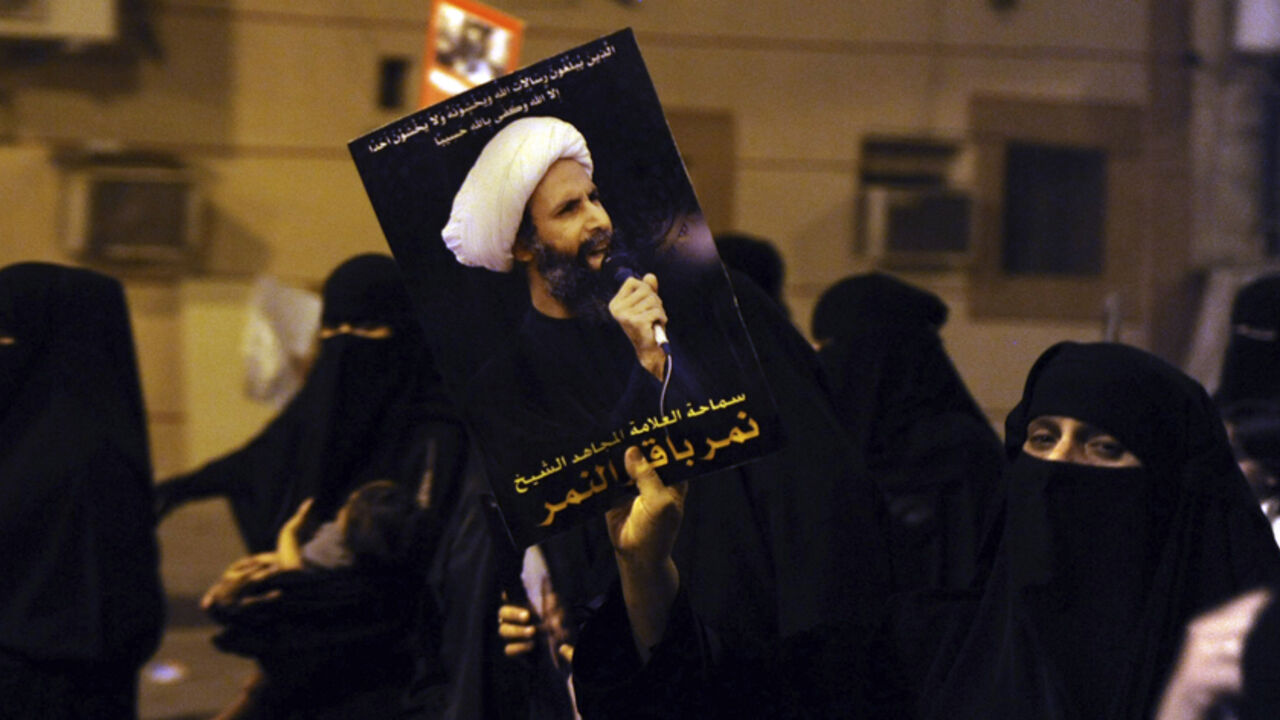 A protester holds up a picture of Sheikh Nimr during a rally in Qatif, against Sheikh Nimr's arrest A protester holds up a picture of Sheikh Nimr al-Nimr during a rally at the coastal town of Qatif, against Sheikh Nimr's arrest July 8, 2012. Sheikh Nimr, a prominent Shi'ite Muslim cleric who was wanted by the police, was detained in Saudi Arabia's Eastern Province on Sunday over calls for more rights for the minority Muslim sect in the Sunni monarchy, his brother and an activist said. REUTERS/Stringer (SAUDI ARABIA - Tags: CIVIL UNREST RELIGION POLITICS) - RTR34QU8