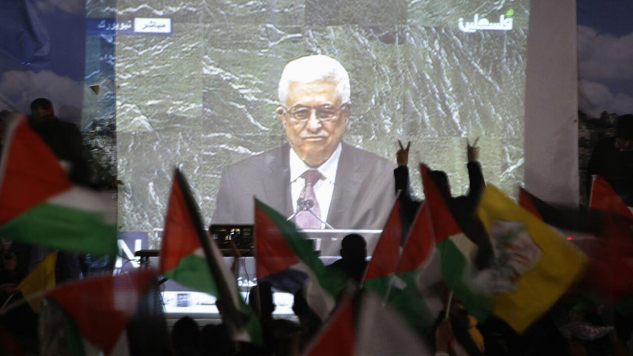Palestinians take part in a rally while the speech of Palestinian President Mahmoud Abbas is being projected in the West Bank city of Ramallah Palestinians take part in a rally while the speech of Palestinian President Mahmoud Abbas is being projected in the West Bank city of Ramallah November 29, 2012. The 193-nation U.N. General Assembly overwhelmingly approved a resolution on Thursday to upgrade the Palestinian Authority's observer status at the United Nations from "entity" to "non-member state," implicitly recognizing a Palestinian state. REUTERS/Mohamad Torokman (WEST BANK - Tags: POLITICS) - RTR3B1GJ