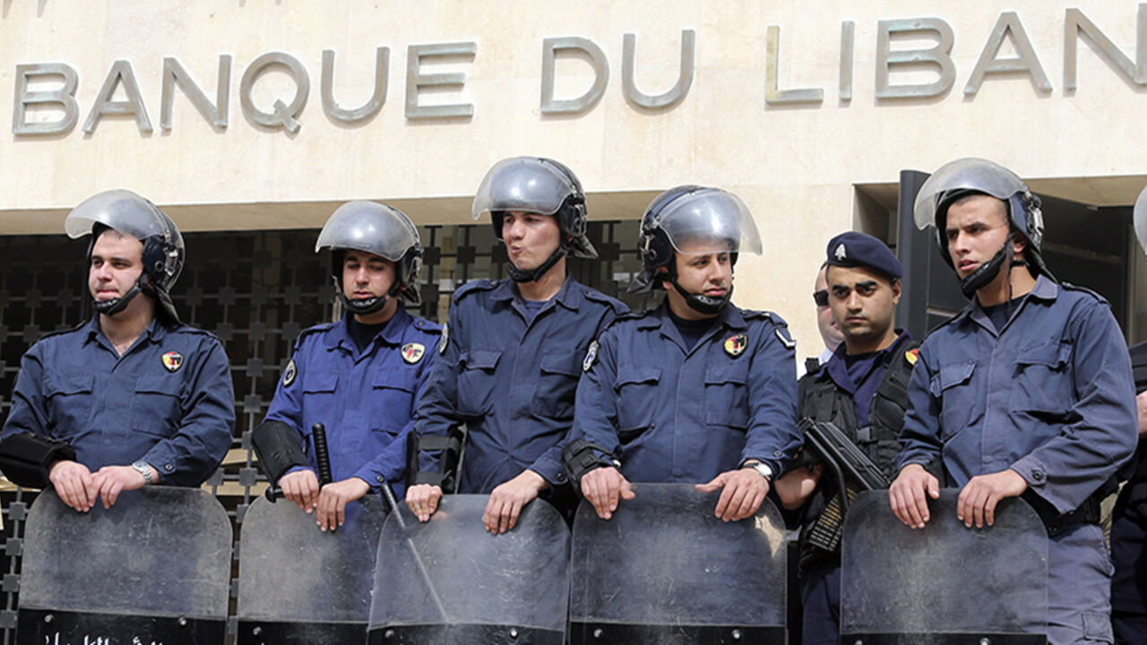 Lebanese riot police stand guard at the Lebanese Central Bank in Beirut Lebanese riot police stand guard at the Lebanese Central Bank in Beirut February 25, 2013. An open-ended strike by teachers and civil servants entered its second week today for the government to approve the wage hike proposal. REUTERS/Mohamed Azakir (LEBANON - Tags: POLITICS CIVIL UNREST) - RTR3E9U4