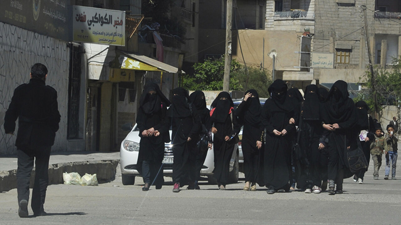 Female school students wearing a full veil (niqab) walk along a street in the northern province of Raqqa Female school students wearing a full veil (niqab) walk along a street in the northern province of Raqqa March 31, 2014. The Islamic State in Iraq and the Levant (ISIL) has imposed sweeping restrictions on personal freedoms in the northern province of Raqqa. Among the restrictions, Women must wear the niqab, or full face veil, in public or face unspecified punishments "in accordance with sharia", or Islamic law. REUTERS/Stringer (SYRIA - Tags: POLITICS CIVIL UNREST CONFLICT RELIGION SOCIETY EDUCATION TPX