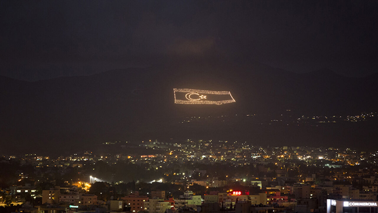 An illuminated flag of the self-declared Turkish Republic of Northern Cyprus is seen overlooking Nicosia An illuminated flag of the self-declared Turkish Republic of Northern Cyprus, which is recognised only by Turkey, is seen overlooking Nicosia March 12, 2014. Greek and Turkish Cypriots have lived estranged for decades. A power-sharing government crumbled soon after independence from Britain in 1960 and the island has been divided since a Greek Cypriot coup was followed by a Turkish invasion of the north in 1974. Four decades on, a United Nations-controlled buffer zone splits Cyprus east to west, with Cyprus