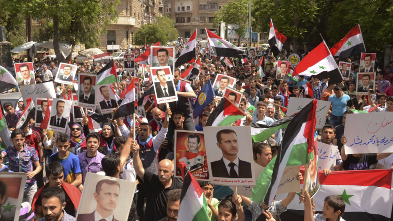 Supporters of Syria's President Bashar al-Assad take part in a rally showing support a day after he declared that he would seek re-election in June, in Aleppo Supporters of Syria's President Bashar al-Assad take part in a rally showing support a day after he declared that he would seek re-election in June, in Aleppo April 29, 2014. Al-Assad declared on Monday he will seek re-election in June, defying calls from his opponents to step aside and allow a political solution to the devastating civil war stemming from protests against his rule. REUTERS/George Ourfalian (SYRIA - Tags: POLITICS ELECTIONS) - RTR3N3ED