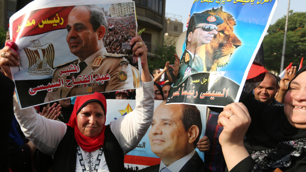 People celebrate in front of a polling station during the presidential elections in Cairo People celebrate in front of a polling station during the presidential elections in Cairo May 26, 2014. Egyptians voted on Monday in a presidential election expected to sweep former army chief Abdel Fatah al-Sisi into office, with supporters brushing aside concerns about human rights and hailing him as the strong leader the country needs. REUTERS/Mohamed Abd El Ghany (EGYPT - Tags: POLITICS ELECTIONS) - RTR3QYDW