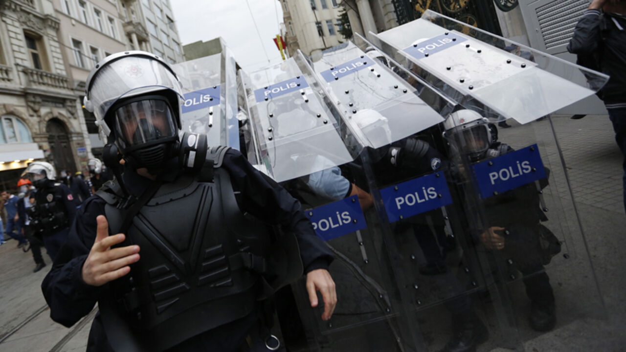 Turkish riot police use their shields to protect themselves as they clash with demonstrators during a protest in central Turkish riot police use their shields to protect themselves as they clash with demonstrators during a protest in central Istanbul May 31, 2014. On the first anniversary of nationwide protests that shook Prime Minster Tayyip Erdogan's rule, barely a thousand anti-government demonstrators marched in Istanbul on Saturday. Outnumbered by riot police, they were soon sent scurrying into side streets by tear gas and water cannon. Their scant numbers were an illustration of Erdogan's tightening grip on power despit