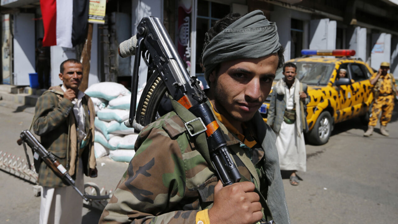 Policeman carries his weapon as he mans a checkpoint in Sanaa A policeman carries his weapon as he mans a checkpoint in Sanaa September 25, 2014. Yemeni President Abd-Rabbu Mansour Hadi has warned Yemenis their country is heading towards civil war after the takeover of the capital by Shi'ite Muslim rebels, a move that has allowed the insurgents to dictate terms to a weakened, fractured government. REUTERS/Khaled Abdullah (YEMEN - Tags: POLITICS CIVIL UNREST MILITARY CRIME LAW) - RTR47NQU