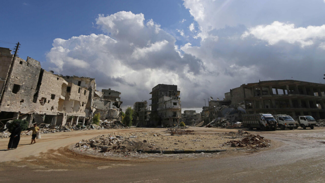 Civilians walk past damaged buildings in Aleppo's eastern district of Tariq al-Bab Civilians walk past damaged buildings in Aleppo's eastern district of Tariq al-Bab September 28, 2014. REUTERS/Hosam Katan (SYRIA - Tags: POLITICS CIVIL UNREST CONFLICT) - RTR481GO