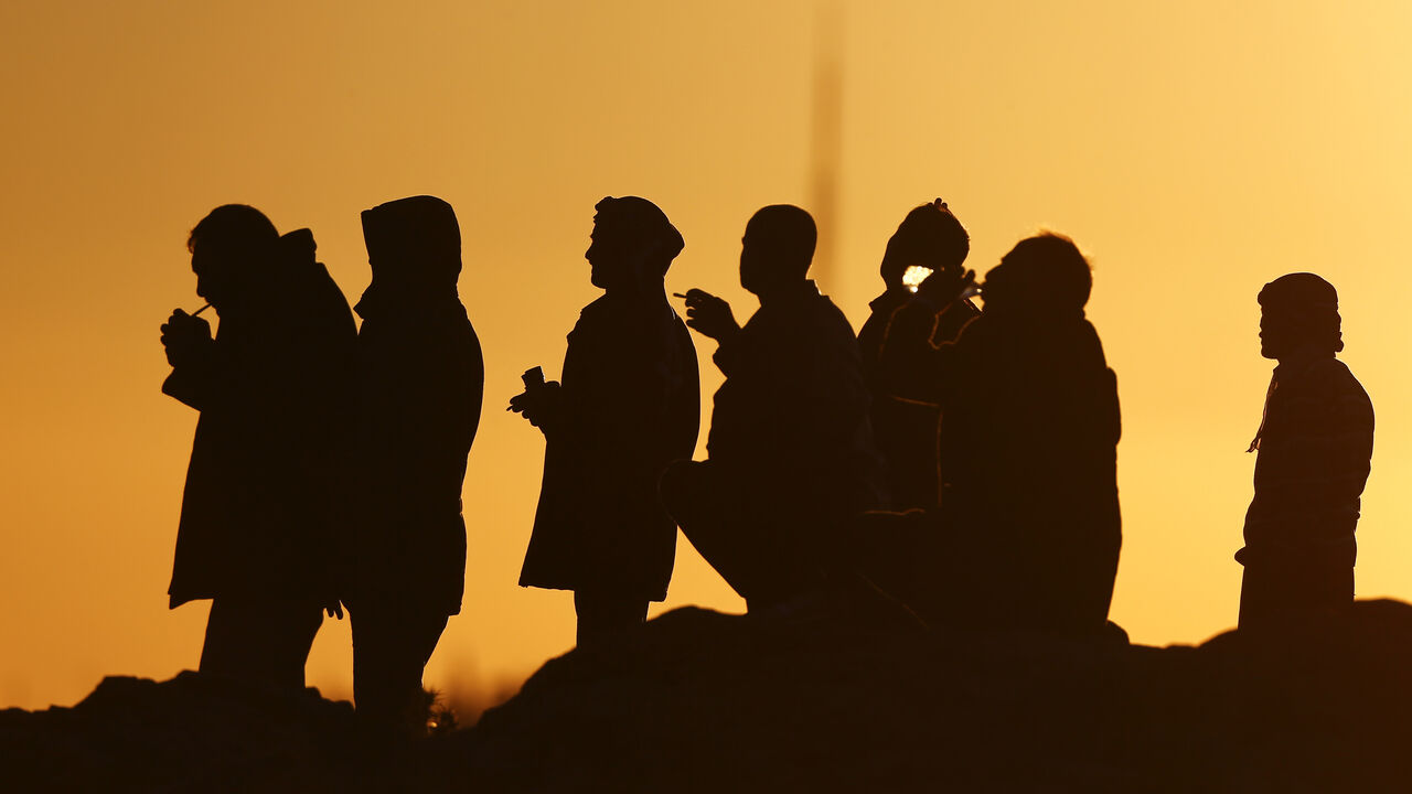 Turkish Kurds watch the Syrian town of Kobani from a hill near the Mursitpinar crossing, on the Turkish-Syrian border Turkish Kurds watch the Syrian town of Kobani from a hill near the Mursitpinar crossing, on the Turkish-Syrian border in the southeastern town of Suruc in Sanliurfa province October 20, 2014. Turkish Foreign Minister Mevlut Cavusoglu said on Monday that Turkey was facilitating the passage of Iraqi Kurdish peshmerga fighters to Kobani to aid Syrian Kurds defending the town against Islamic State militants. REUTERS/Kai Pfaffenbach (TURKEY - Tags: MILITARY CONFLICT POLITICS) - RTR4AUOP